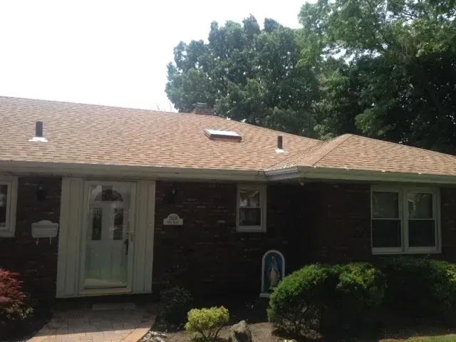 Brick ranch home with a newly installed asphalt shingle roof